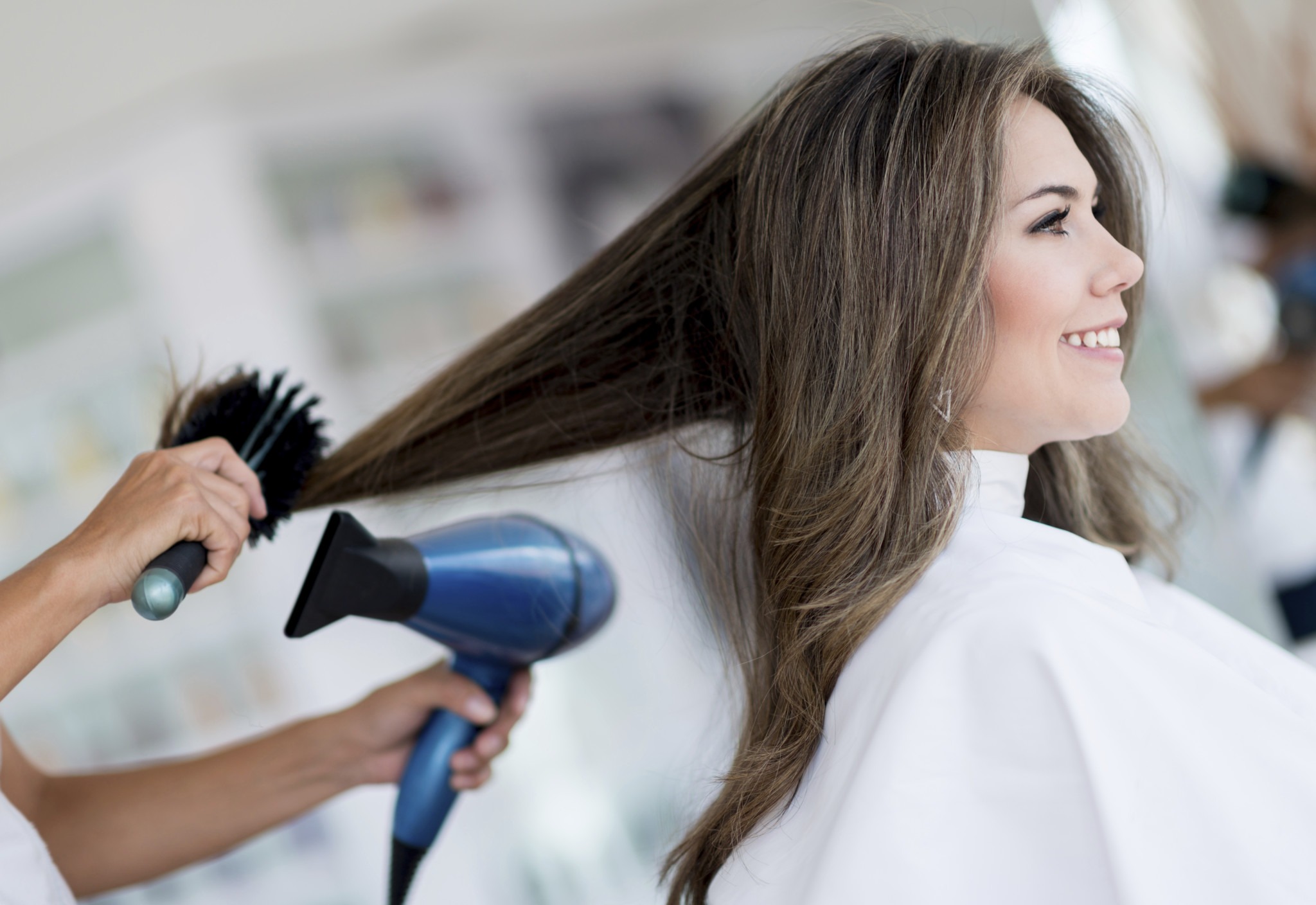 happy woman salon have her hair blowdried